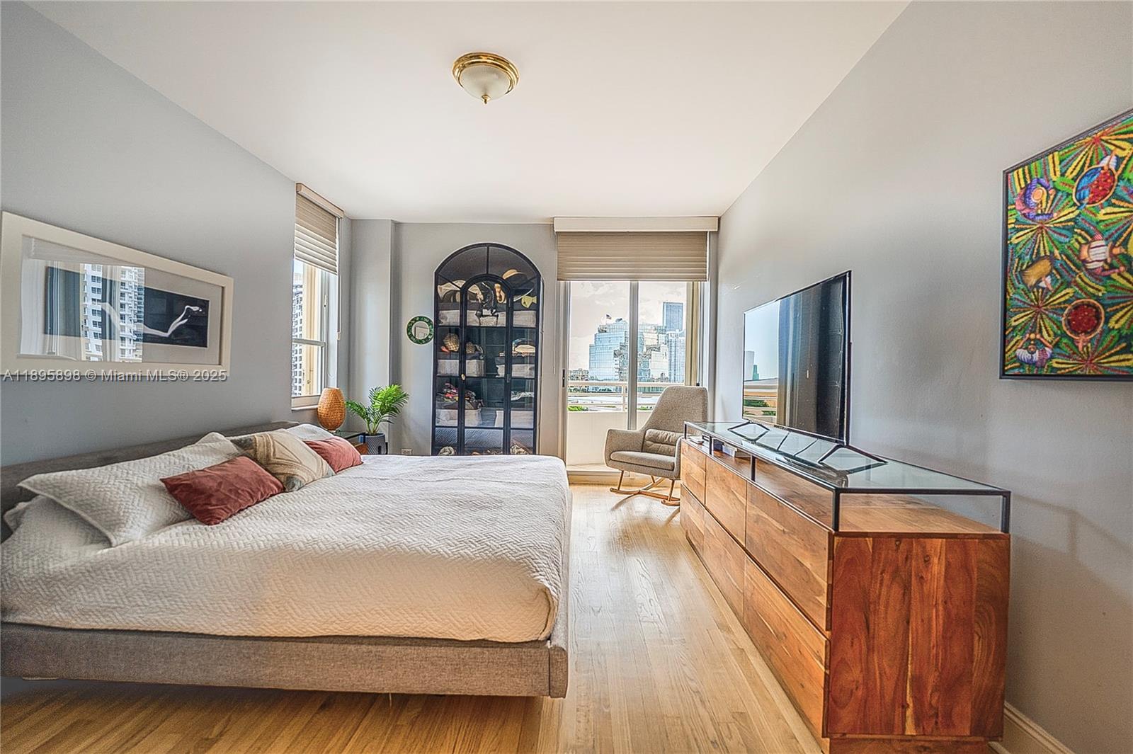 888 Brickell Key Drive, Unit 903 Miami, FL 33131 - Photo 10 of 38 a bedroom with a bed and a flat screen tv