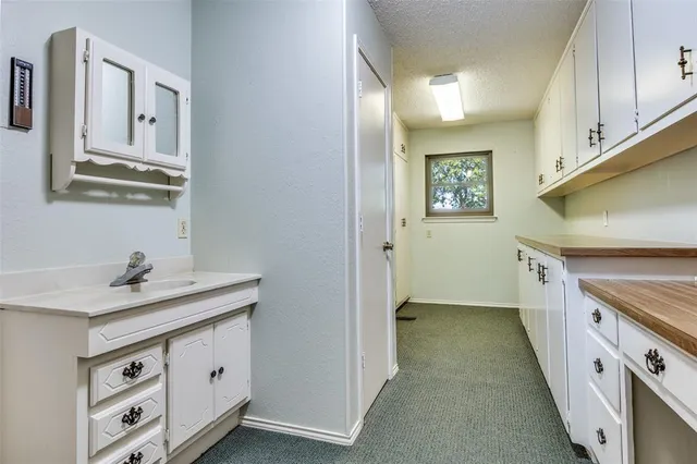 a utility room with cabinets washer and dryer