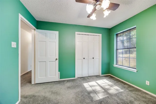 an empty room with windows and closet