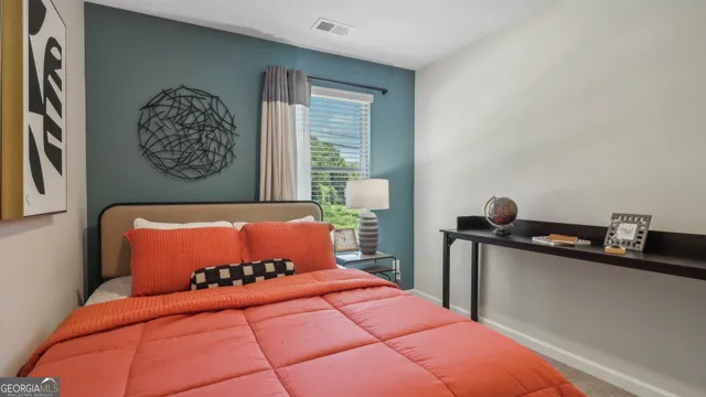 a bedroom with a bed and window