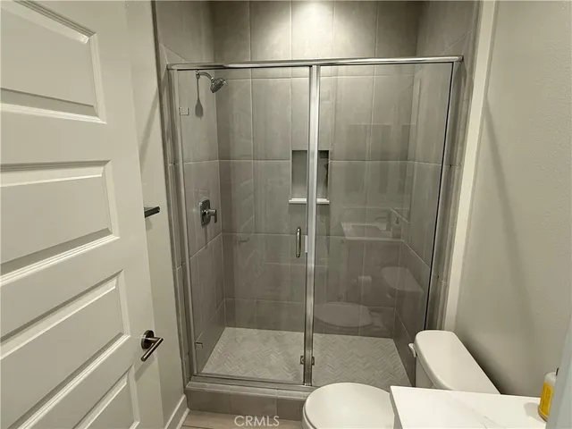 a bathroom with a shower and toilet