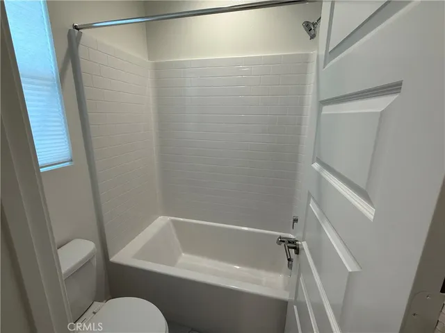 a bathroom with a shower and toilet