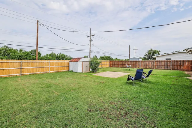 a view of a house with a yard balcony and sitting area