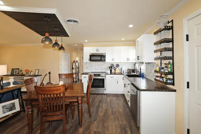 a large kitchen with a table and chairs