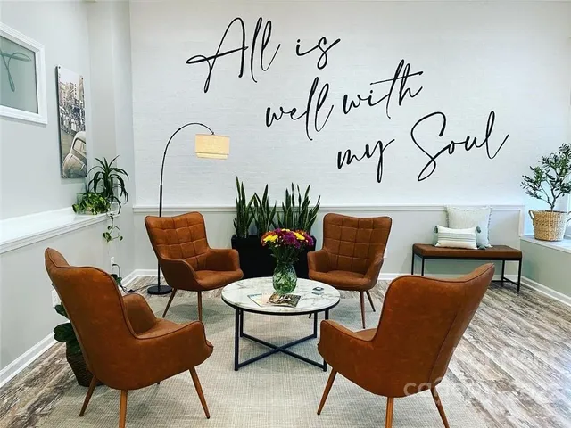 a view of a livingroom with furniture and kitchen