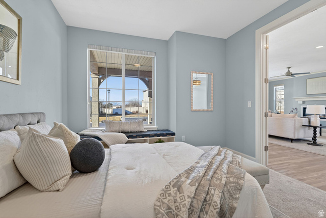 1222 West 190th Street North Mapleton, UT 84664 - Photo 32 of 46 Spacious bedroom featuring light blue walls, a large window with white grid panes, and a built-in window seat