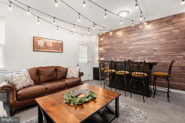 a kitchen with stainless steel appliances granite countertop a stove top oven a sink and dishwasher with white cabinets