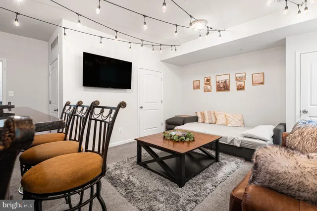 a living room with lots of furniture and a wooden floor