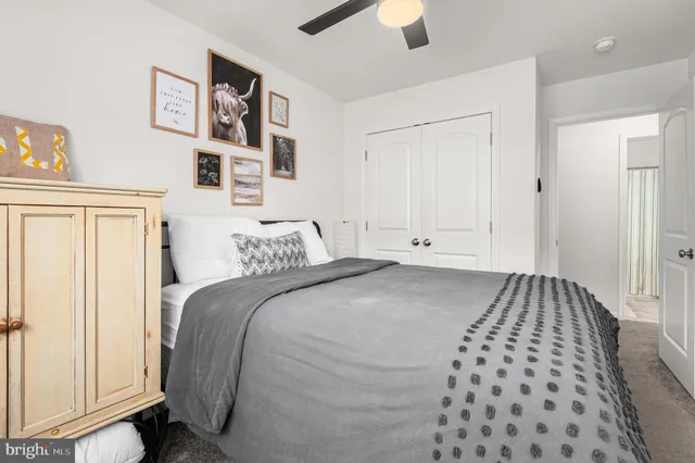 a bedroom with a large bed and a couch