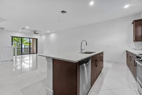 a kitchen with a sink and a refrigerator