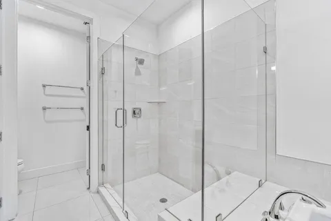 a bathroom with a tub a sink and a shower