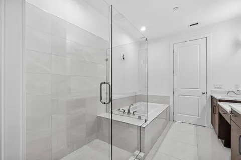 a bathroom with a bathtub and a shower