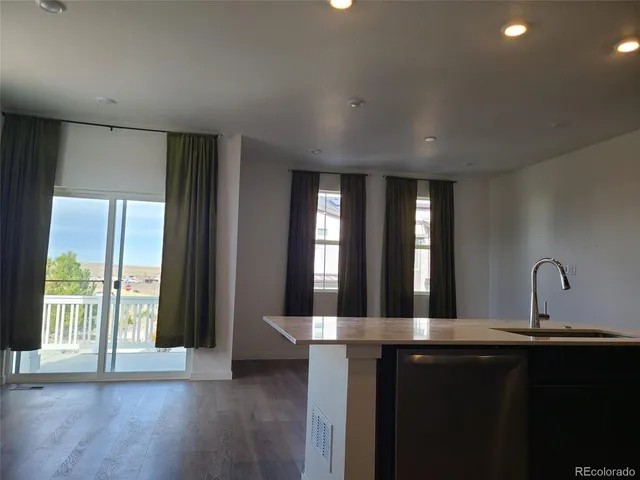 a kitchen with large windows and a sink
