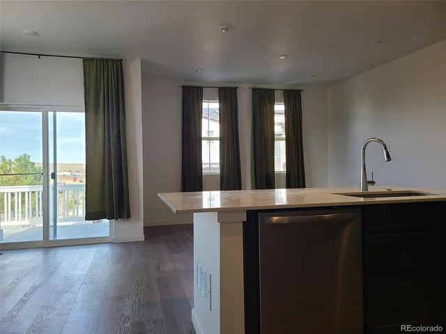 a kitchen with a sink and large window