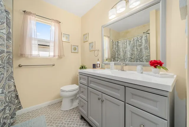 a bathroom with a sink toilet and a mirror