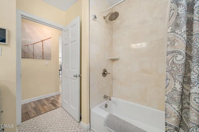 a bathroom with a bathtub and shower
