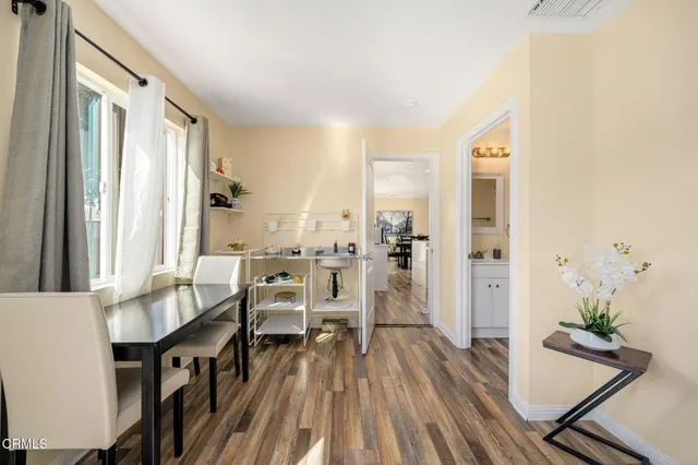 a view of a dining room with furniture window and wooden floor