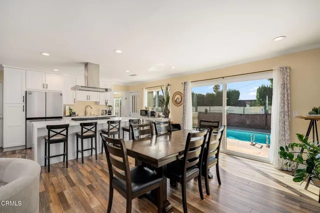 a view of a dining room with furniture window and wooden floor