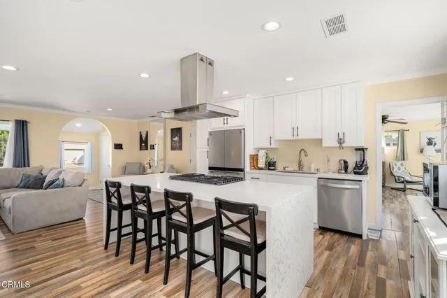 a kitchen with a table chairs refrigerator and cabinets