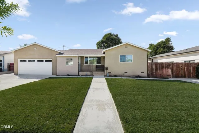 a view of a yard in front of a house with green space