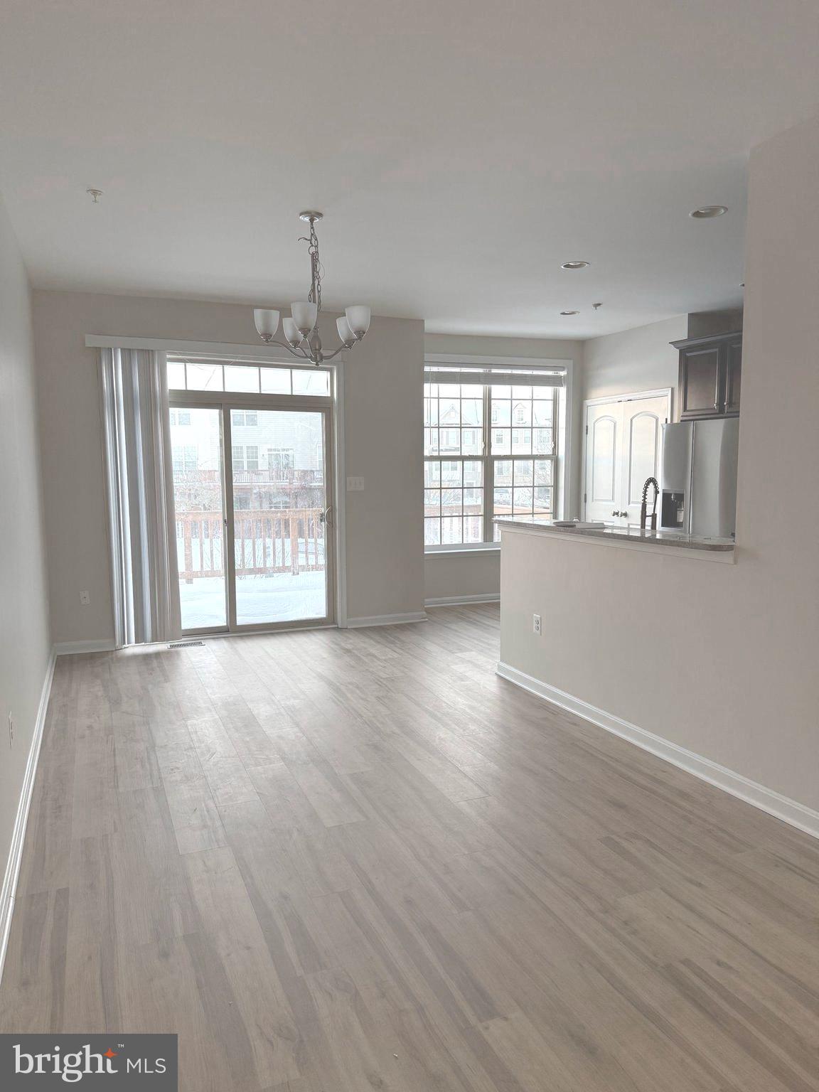 4713 Cambria Road Frederick, MD 21703 - Photo 12 of 67 an empty room with wooden floor and windows