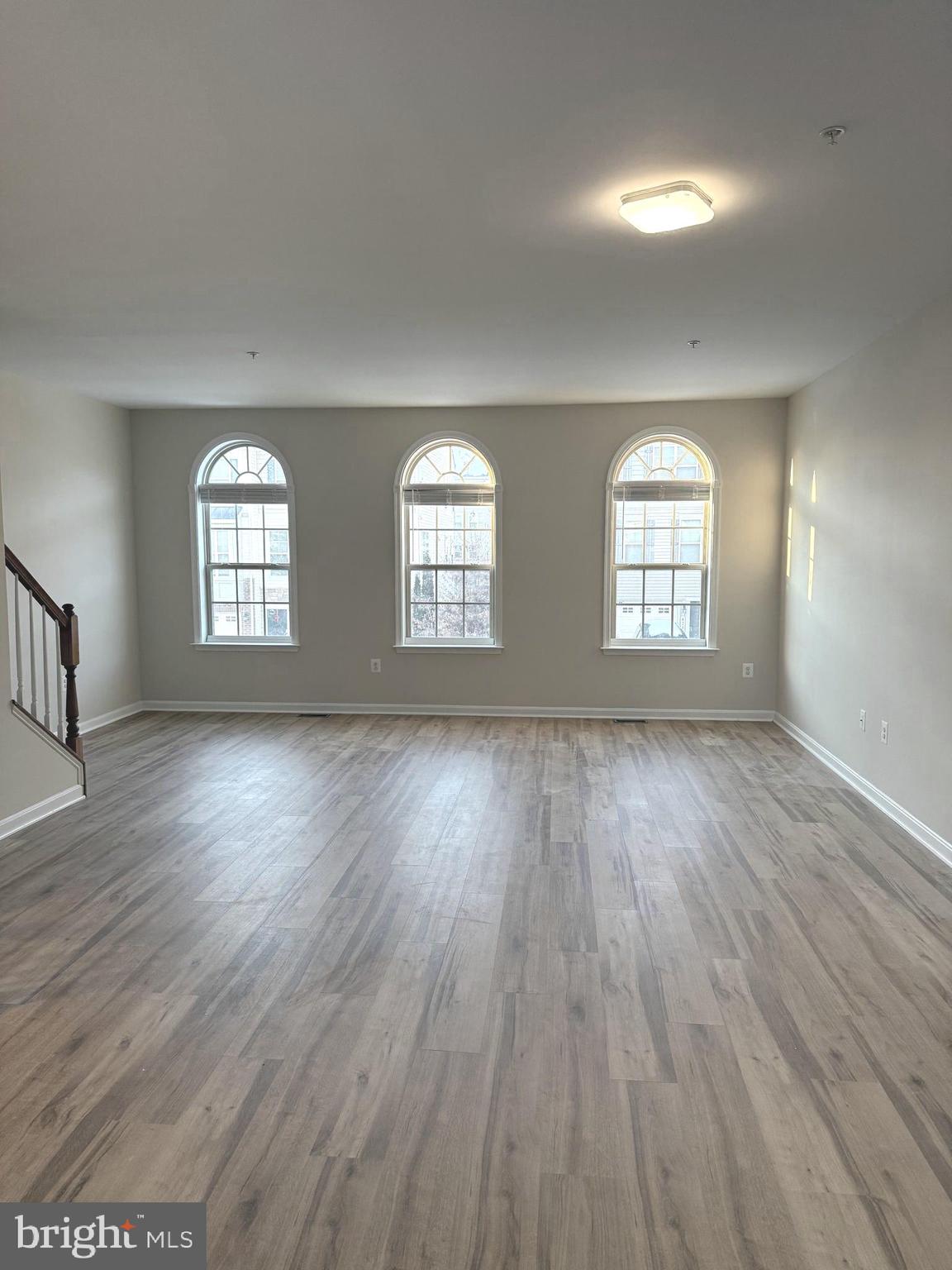 4713 Cambria Road Frederick, MD 21703 - Photo 20 of 67 an empty room with wooden floor and windows