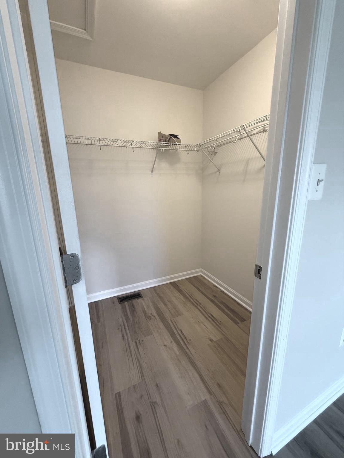 4713 Cambria Road Frederick, MD 21703 - Photo 25 of 67 a view of walk in closet with wooden floor