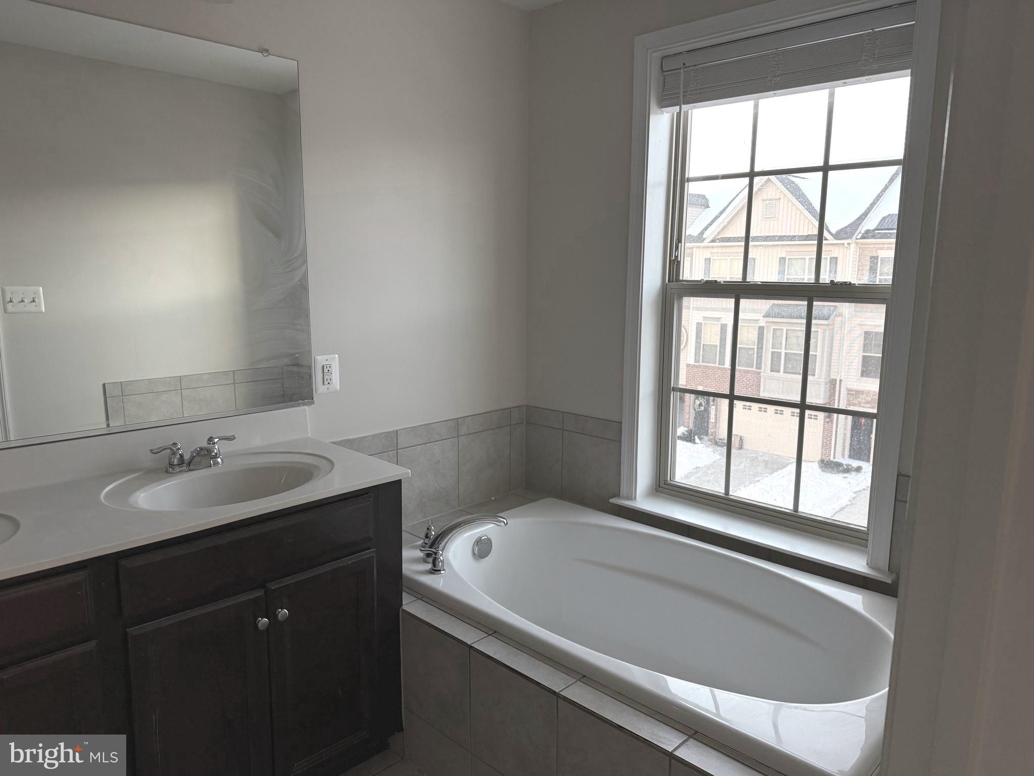 4713 Cambria Road Frederick, MD 21703 - Photo 26 of 67 a bathroom with a tub sink and mirror