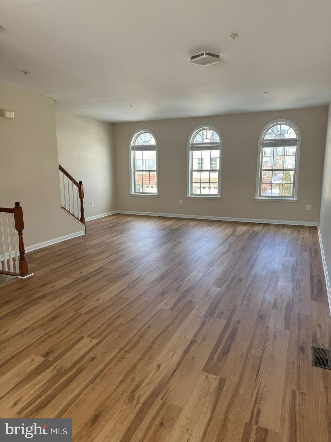 4713 Cambria Road Frederick, MD 21703 - Photo 34 of 67 an empty room with wooden floor and windows