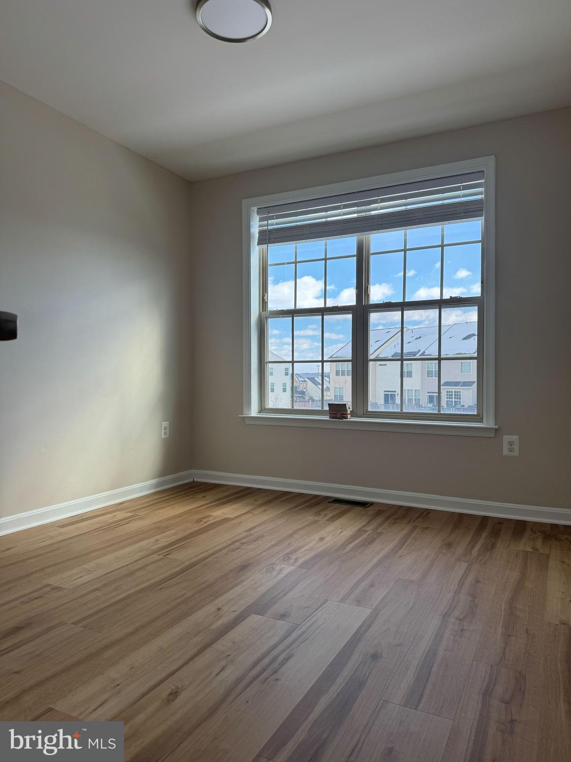 4713 Cambria Road Frederick, MD 21703 - Photo 38 of 67 a view of an empty room with wooden floor and a window