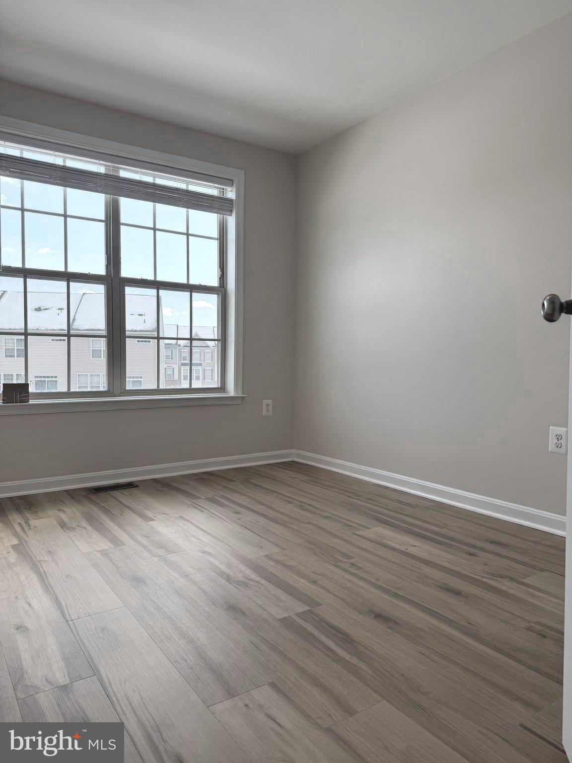 4713 Cambria Road Frederick, MD 21703 - Photo 39 of 67 a view of an empty room with wooden floor and a window