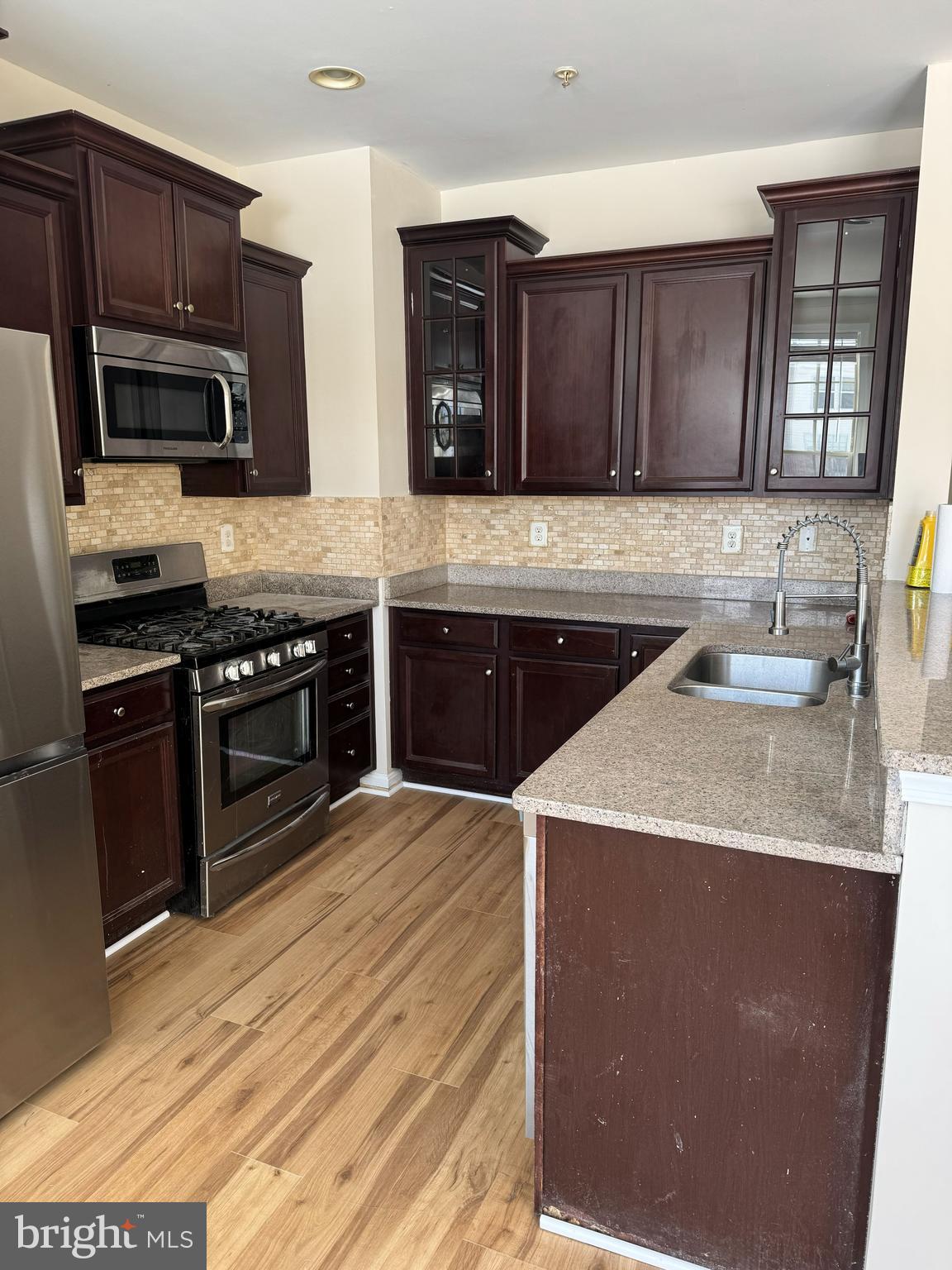 4713 Cambria Road Frederick, MD 21703 - Photo 4 of 67 a kitchen with stainless steel appliances granite countertop wooden cabinets a stove a sink and dishwasher