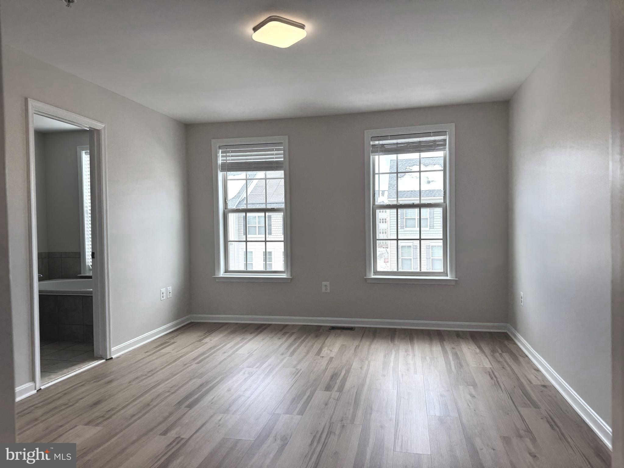 4713 Cambria Road Frederick, MD 21703 - Photo 41 of 67 an empty room with wooden floor and windows