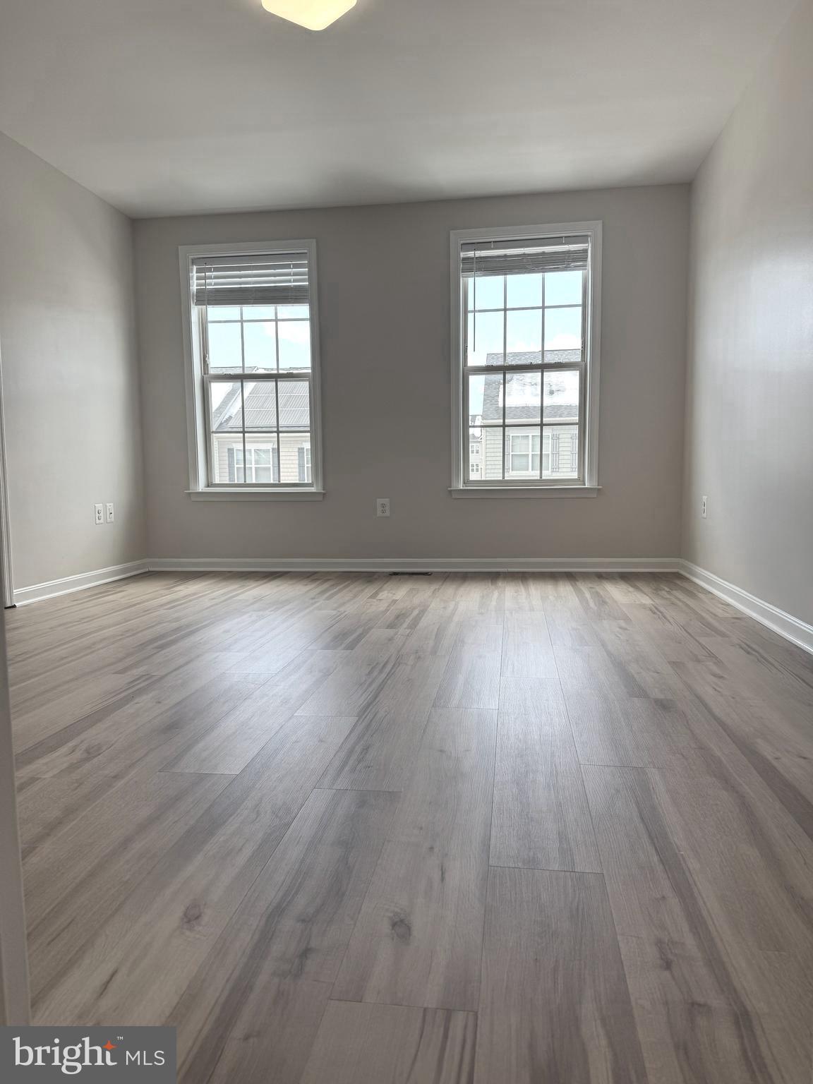 4713 Cambria Road Frederick, MD 21703 - Photo 42 of 67 an empty room with wooden floor and windows