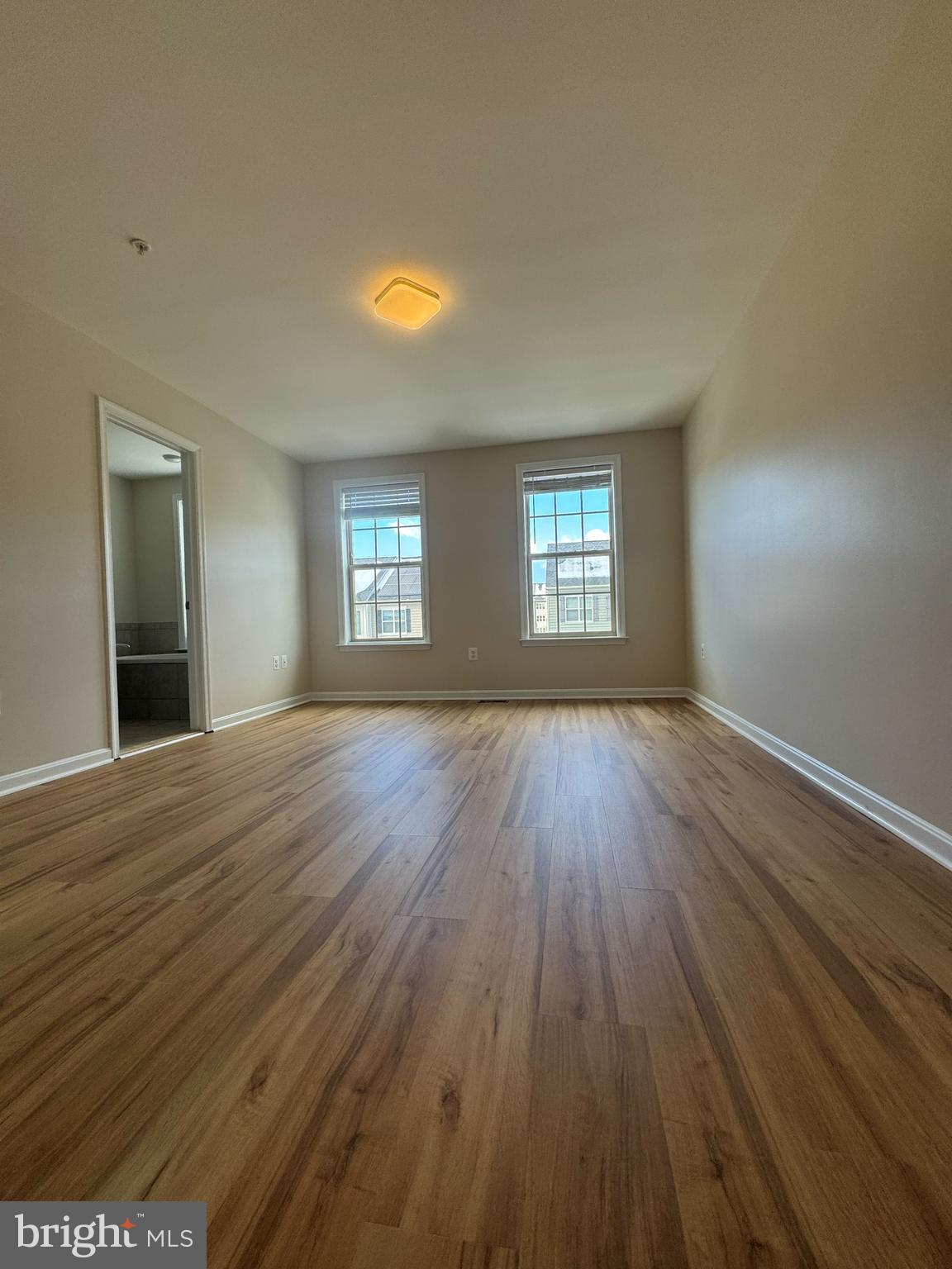 4713 Cambria Road Frederick, MD 21703 - Photo 43 of 67 a view of an empty room with wooden floor and window