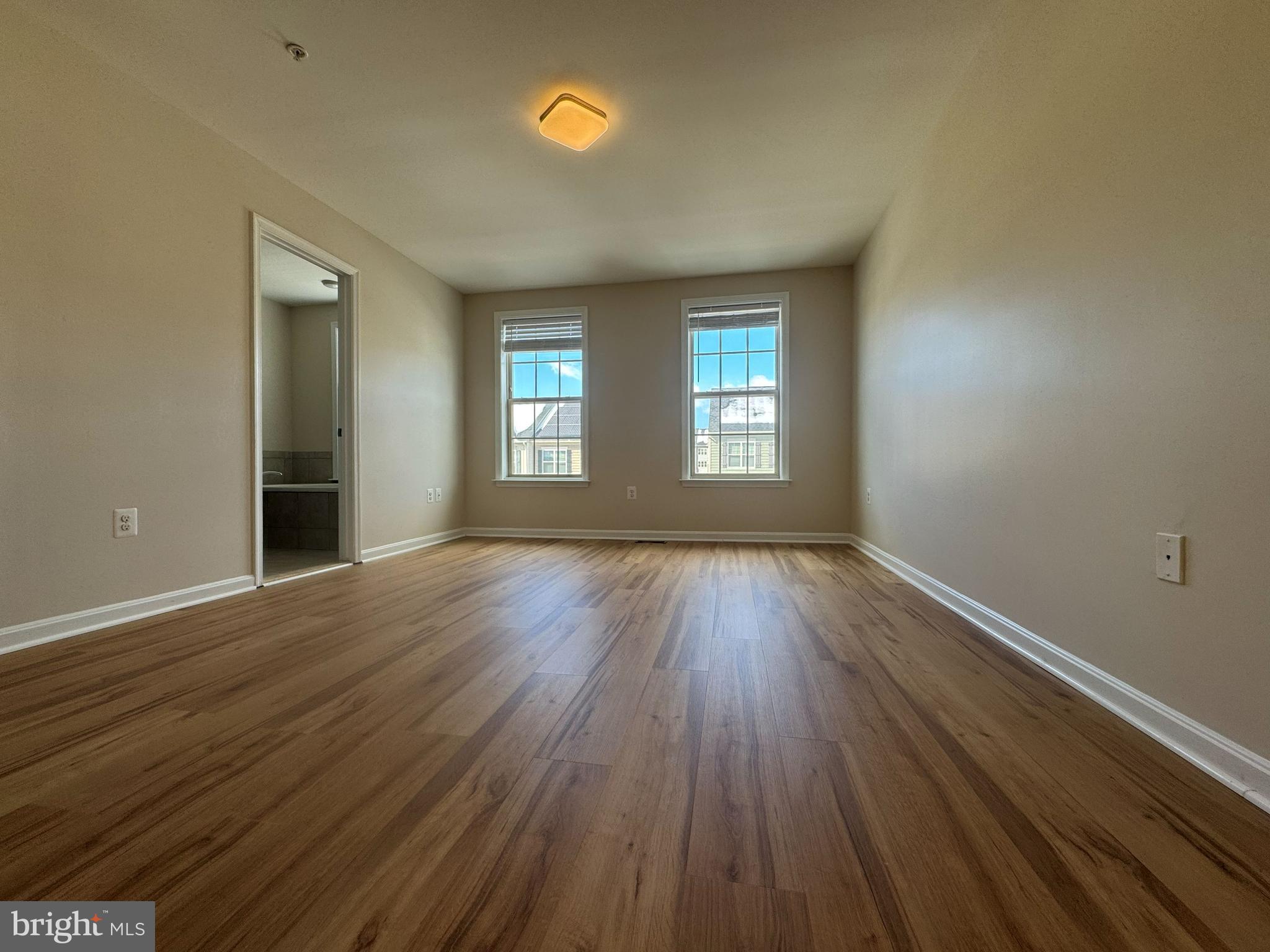 4713 Cambria Road Frederick, MD 21703 - Photo 44 of 67 an empty room with wooden floor and windows