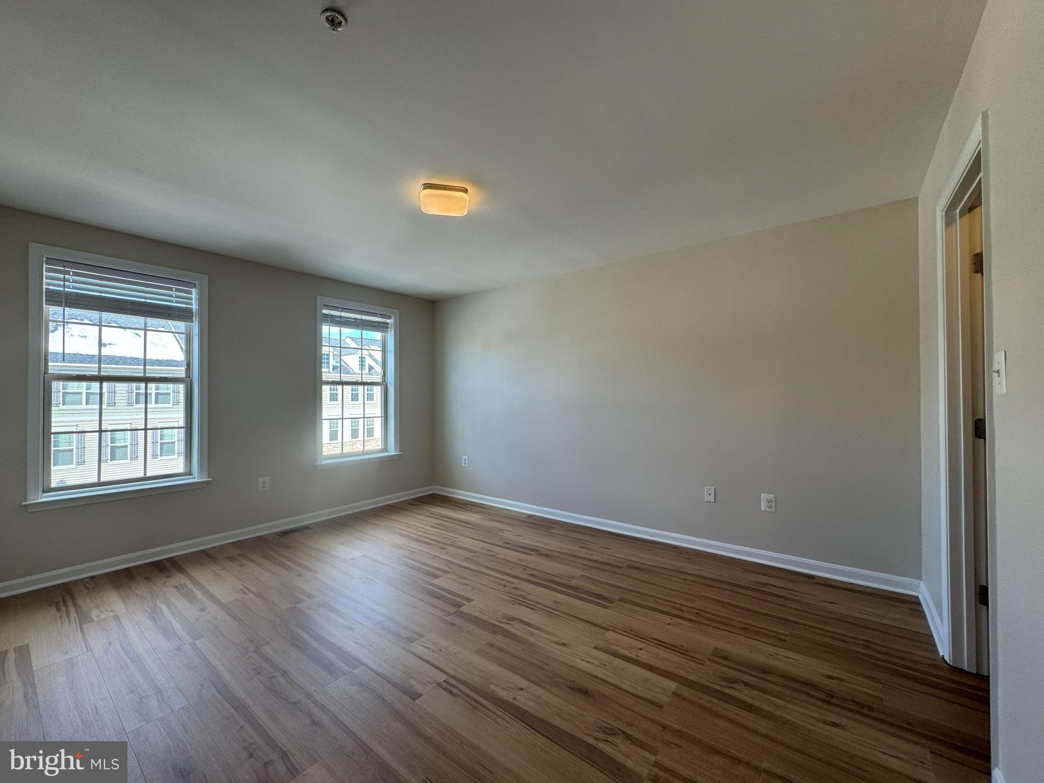 4713 Cambria Road Frederick, MD 21703 - Photo 45 of 67 an empty room with wooden floor and windows