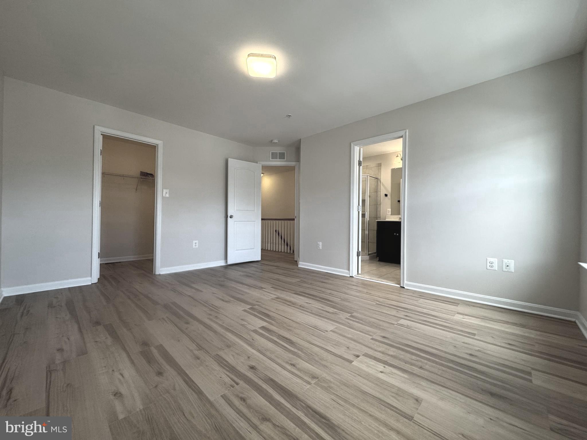 4713 Cambria Road Frederick, MD 21703 - Photo 49 of 67 an empty room with wooden floor and bathroom