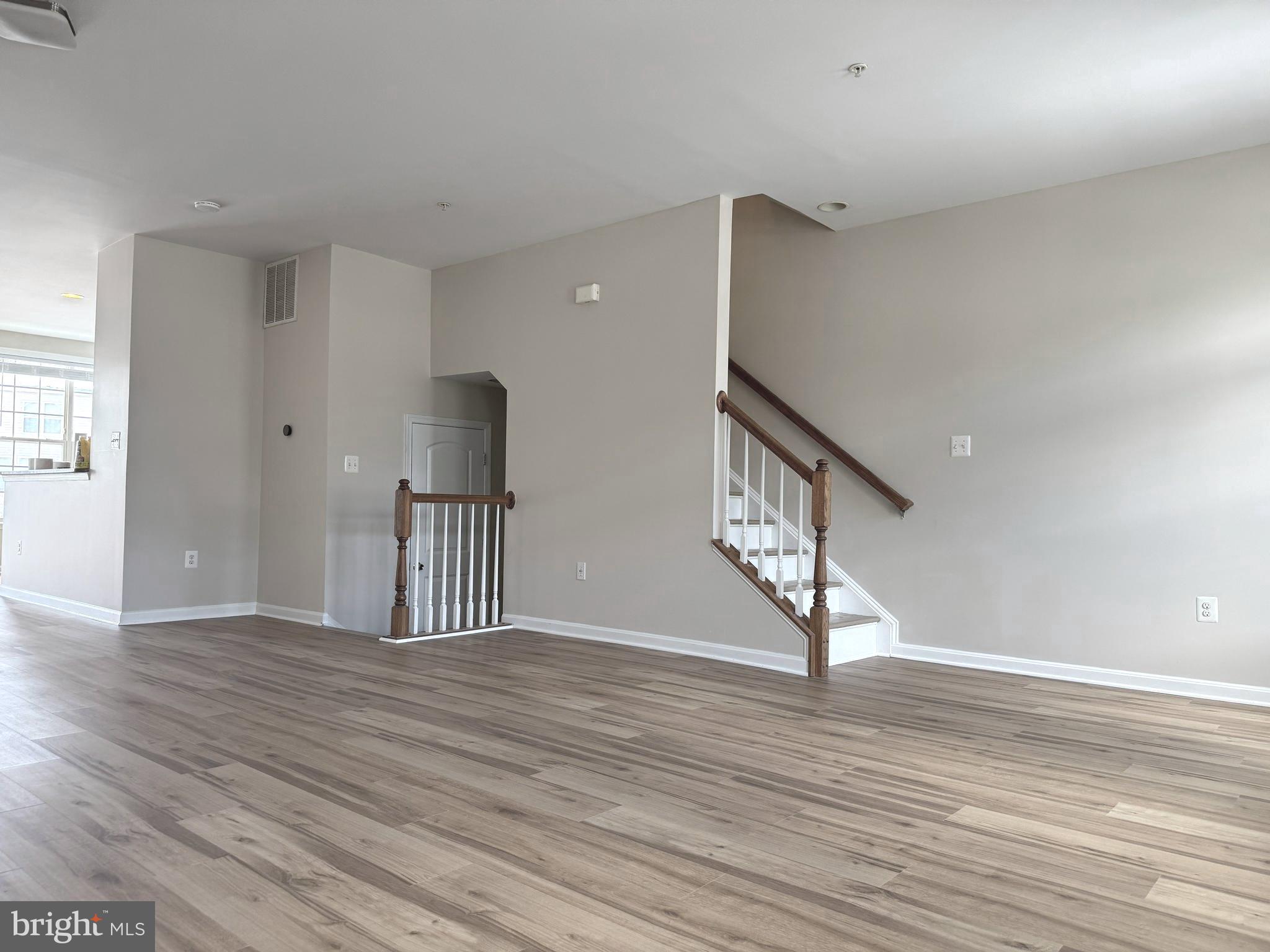 4713 Cambria Road Frederick, MD 21703 - Photo 52 of 67 a view of an empty room with wooden floor and a window