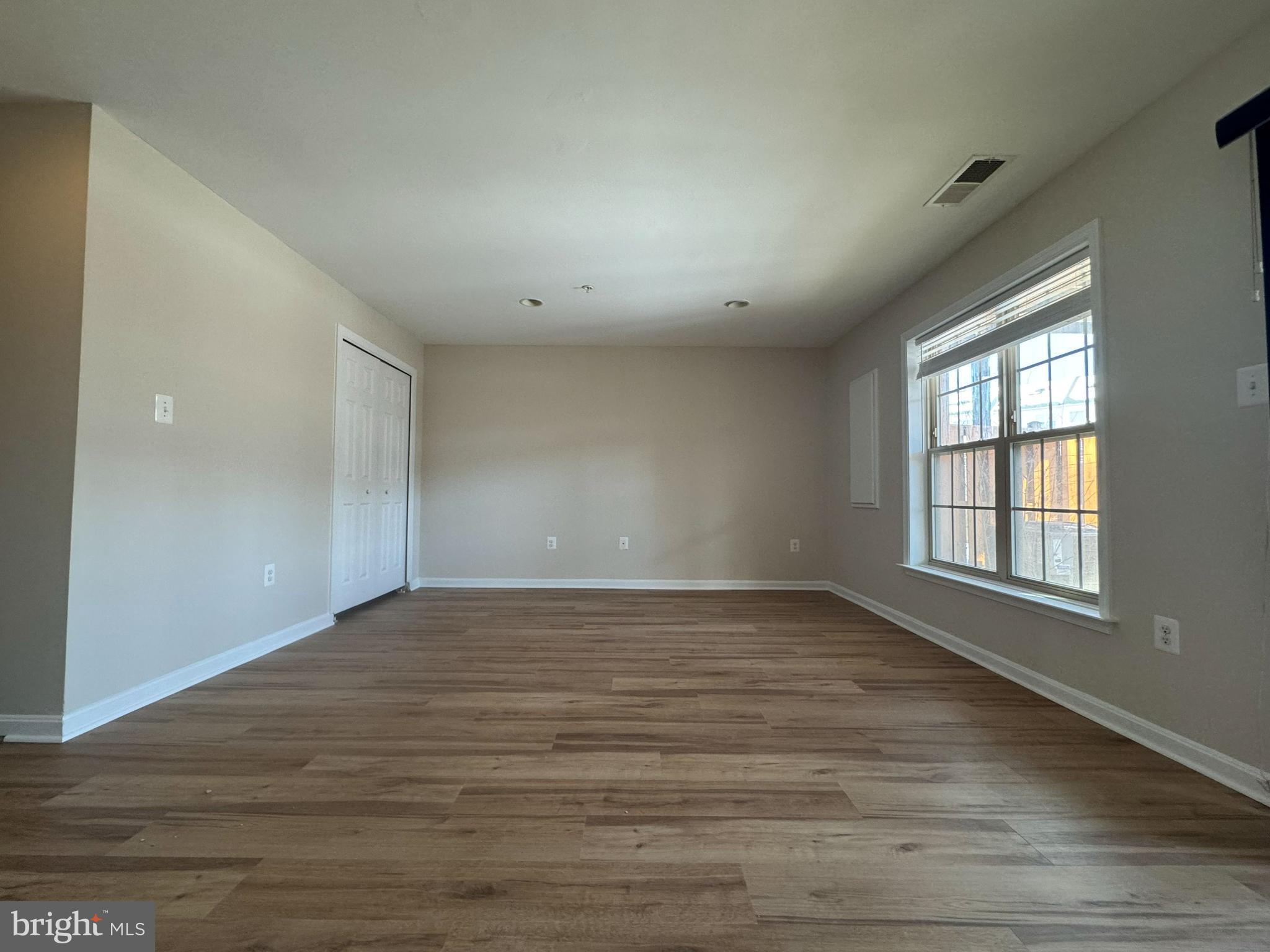 4713 Cambria Road Frederick, MD 21703 - Photo 58 of 67 a view of an empty room with wooden floor and a window