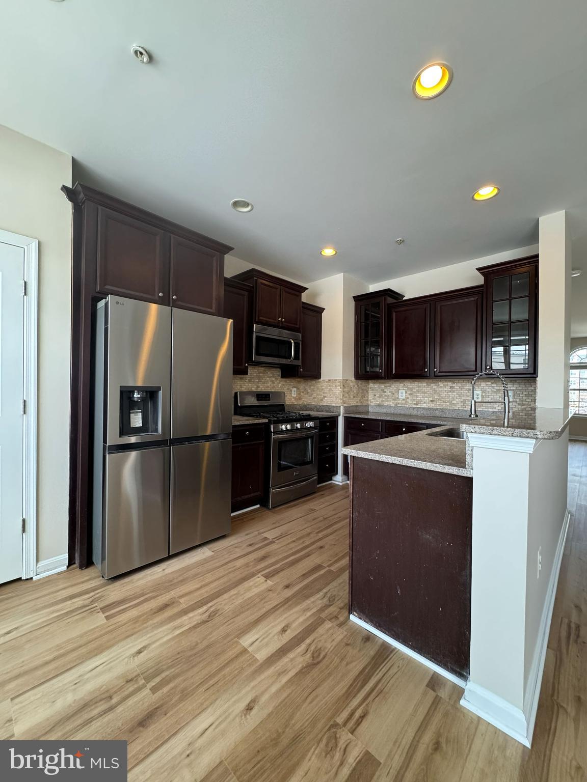 4713 Cambria Road Frederick, MD 21703 - Photo 8 of 67 a kitchen with stainless steel appliances granite countertop a refrigerator a stove a microwave and a sink