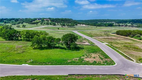 a view of a green field with an outdoor space