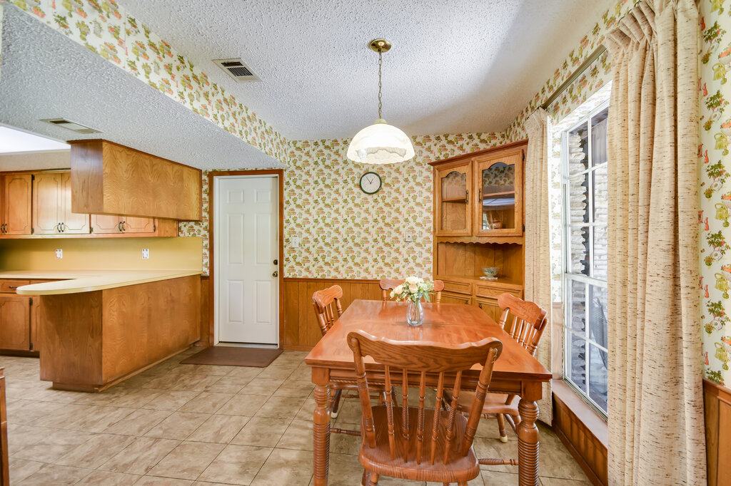 301 Navajo Trail Georgetown, TX 78633 - Photo 21 of 35 Dining space with a textured ceiling, a wainscoted wall, wallpapered walls, and wooden walls