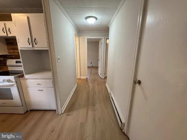 a view of a kitchen from a hallway