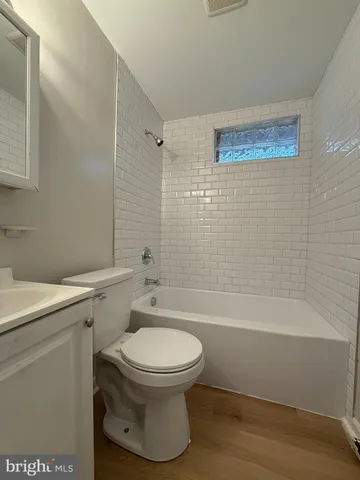 a bathroom with a toilet and a bathtub