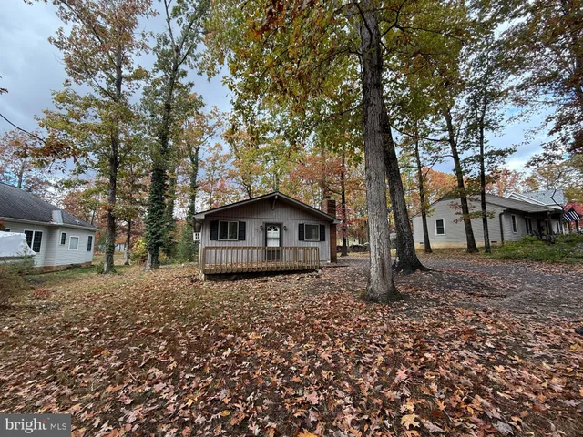 a house that has a tree in front of it