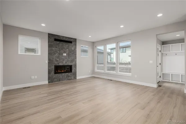 a view of empty room with wooden floor and fireplace