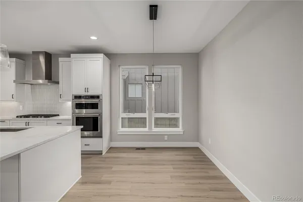 a kitchen with a stove a sink and a refrigerator