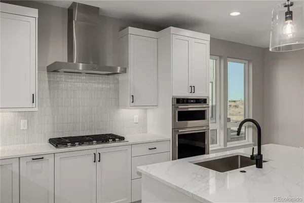 a kitchen with granite countertop a stove and a sink