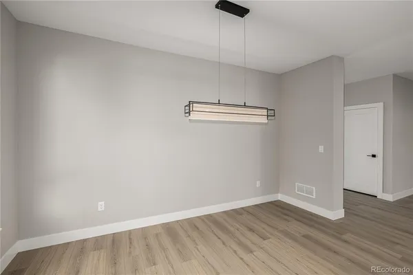 a view of a room with wooden floor